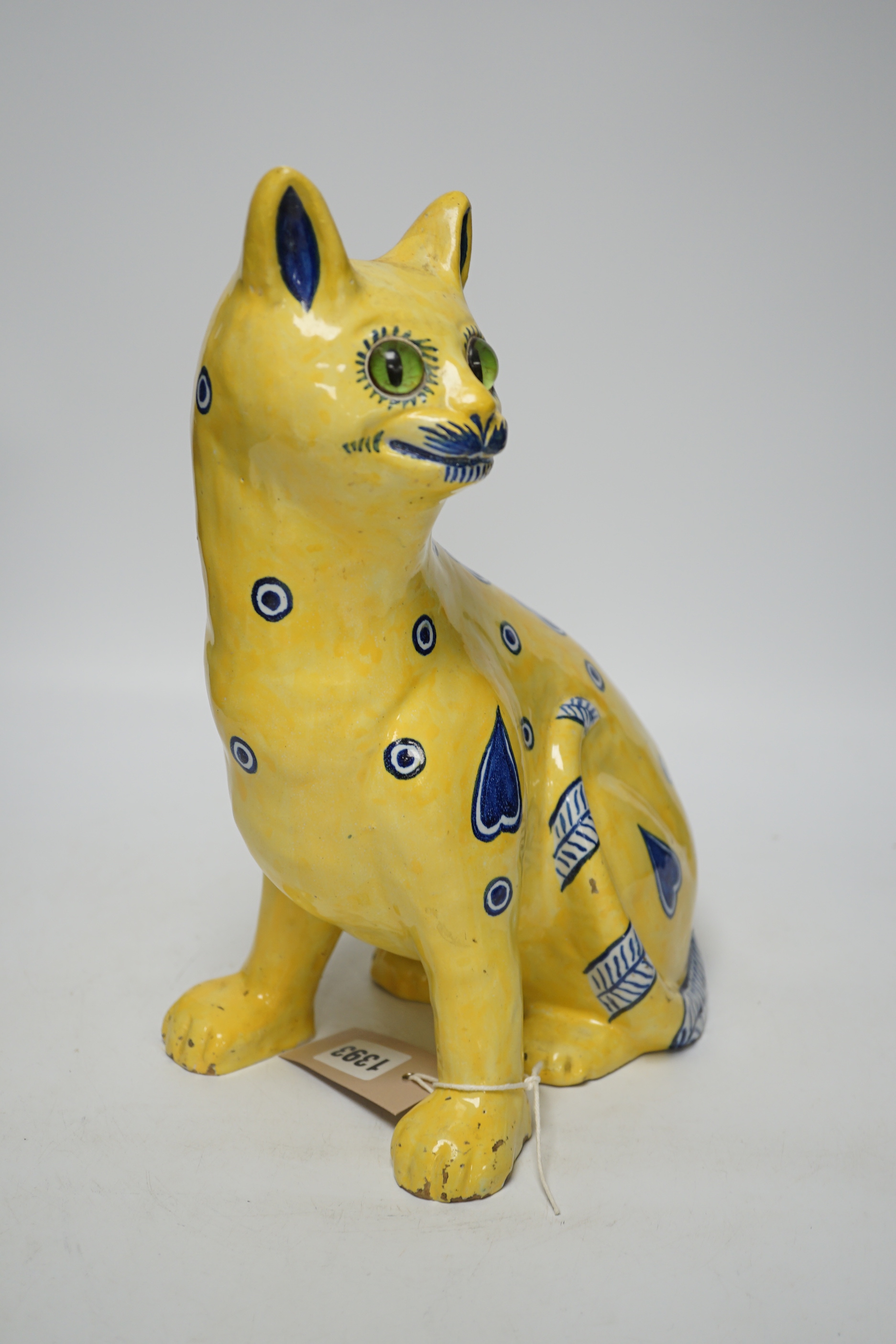 A Mosanic Galle style faience seated cat with glass eyes, c.1900-10, 31cm